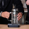 Two people brewing coffee following the Madcap Coffee French Press recipe